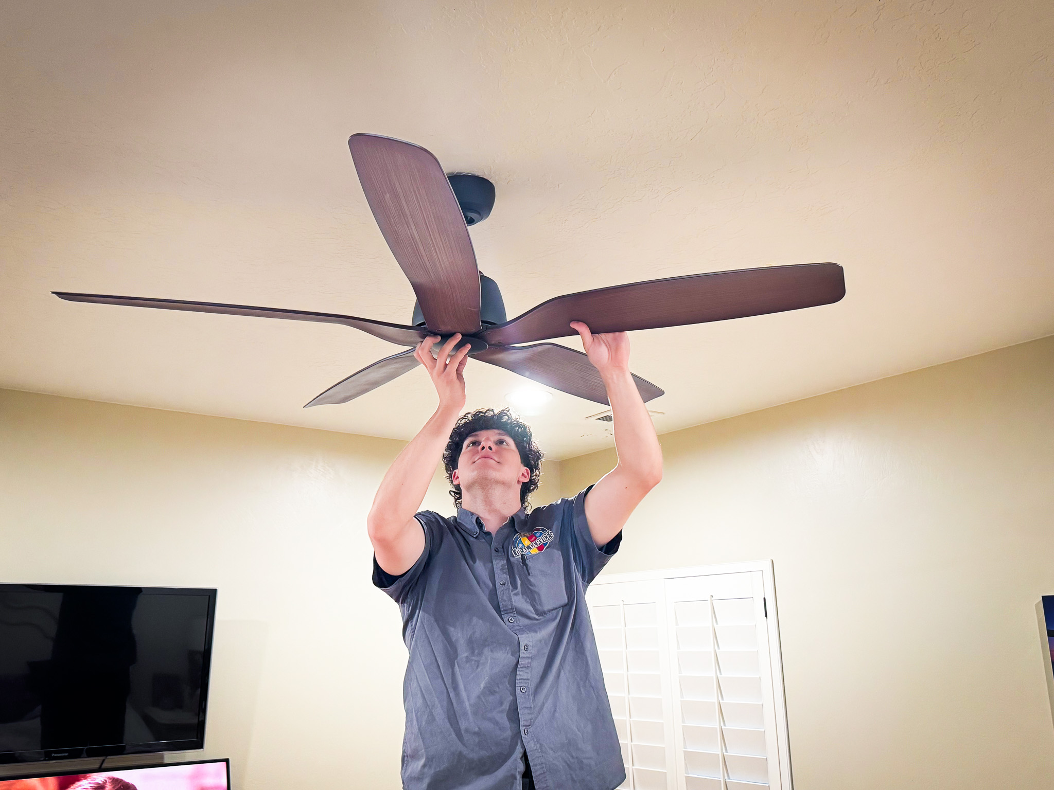 Local Services Inc. technician installing ceiling fan