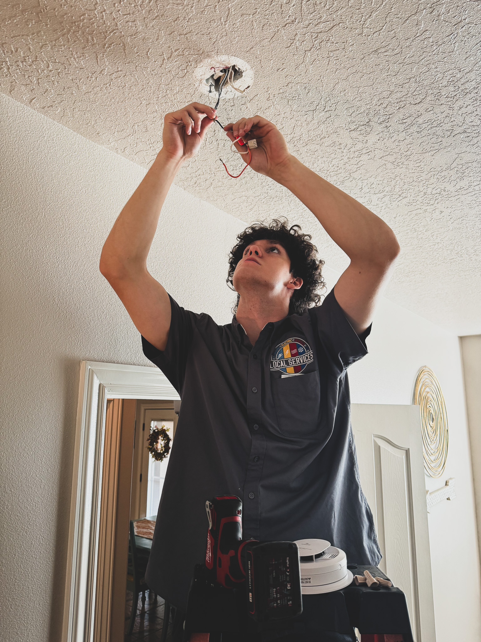 Local Services Inc. tech wiring ceiling light fixture