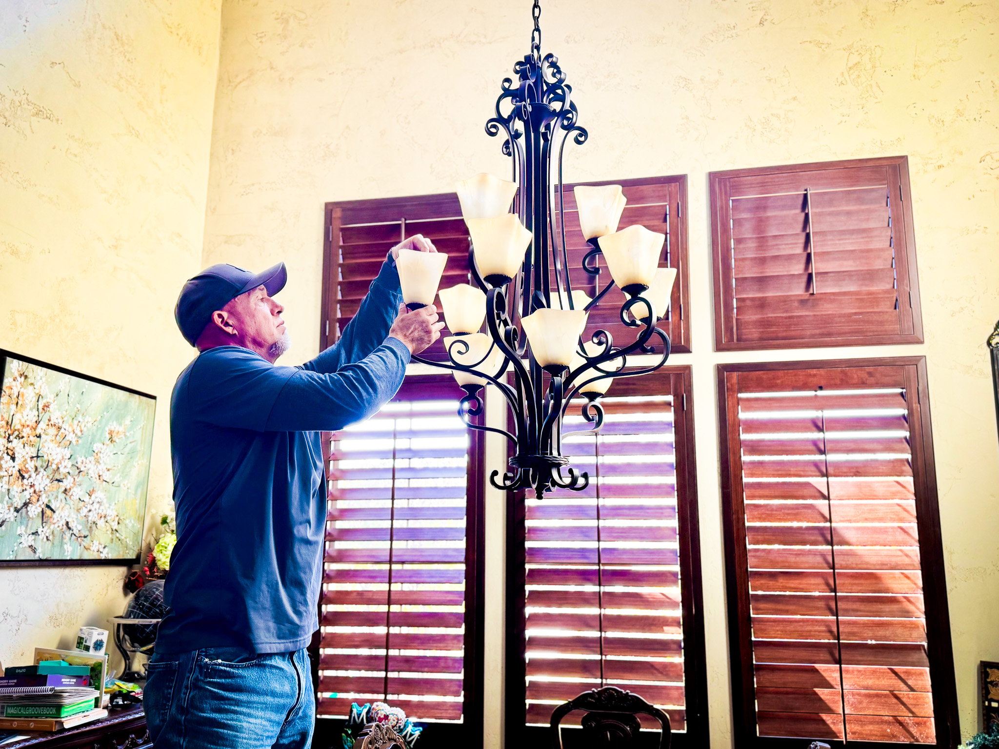 Local Services Inc. tech installing chandelier