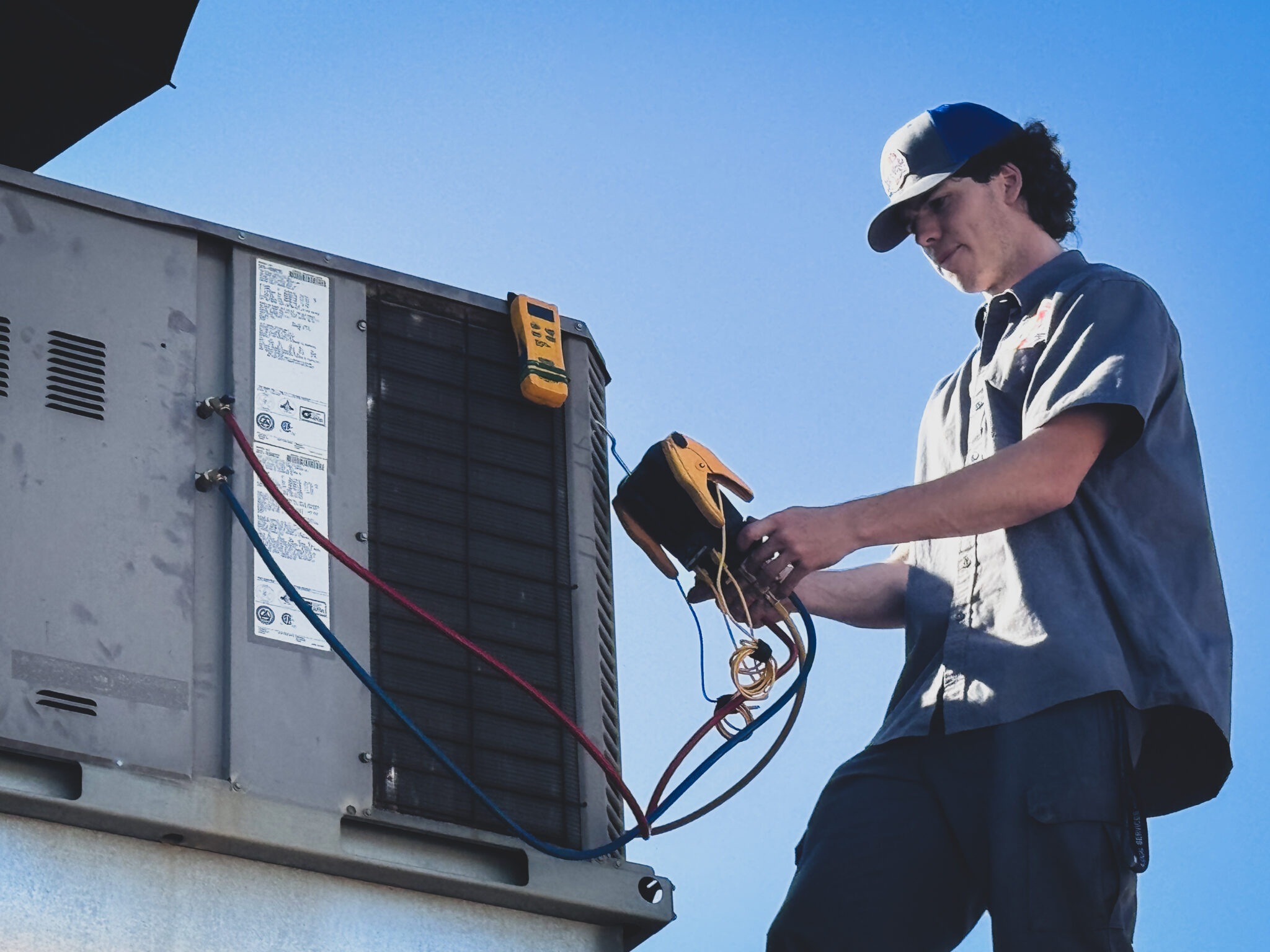 Local Services Inc. technician diagnosing AC unit